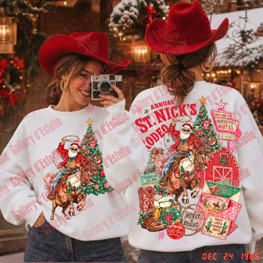 Two women wearing matching white Christmas cowboy sweatshirts, shown from the front and back in a festive outdoor setting. The front features a Santa riding a horse next to a Christmas tree, and the back features a large graphic reading 'Annual St. Nick's Rodeo'
