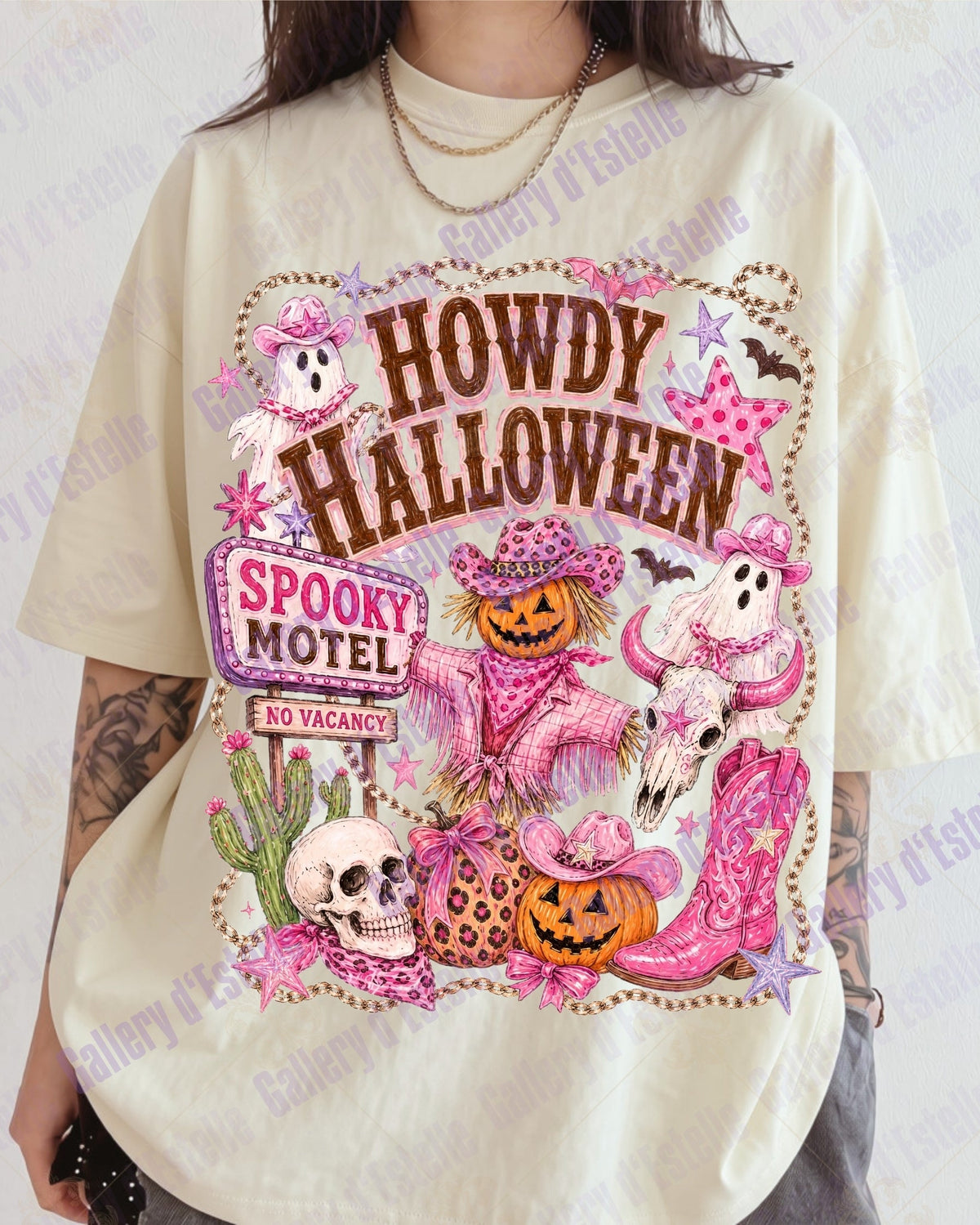 A person wearing an oversized cream-colored graphic t-shirt with a colorful 'Howdy Halloween' print featuring pumpkins, ghosts, skulls, and pink boots.