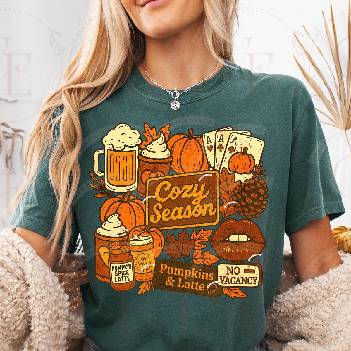 Person wearing a green t-shirt with autumn-themed graphics and text.