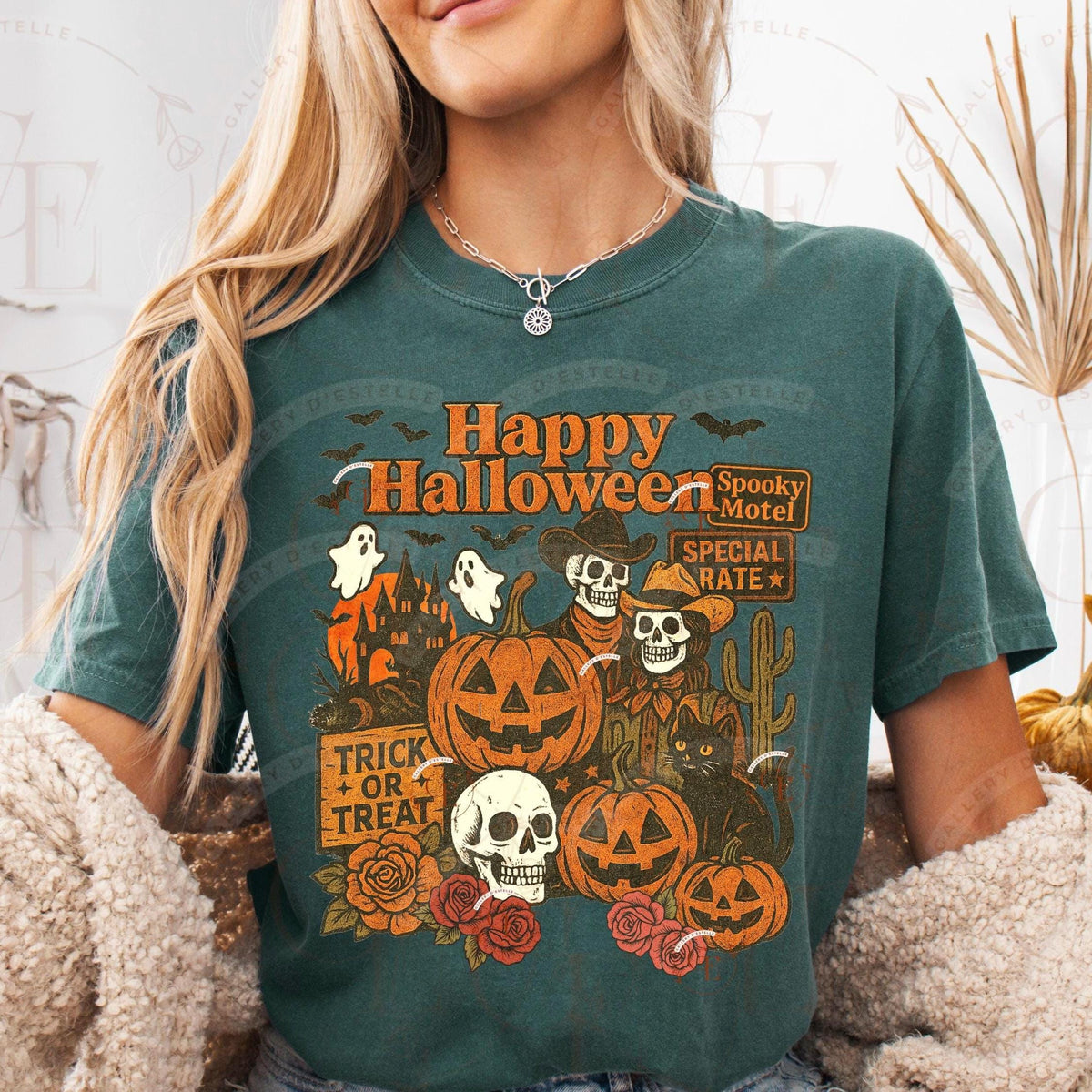 Person wearing a green t-shirt with Halloween-themed design featuring pumpkins, ghosts, and skeletons.