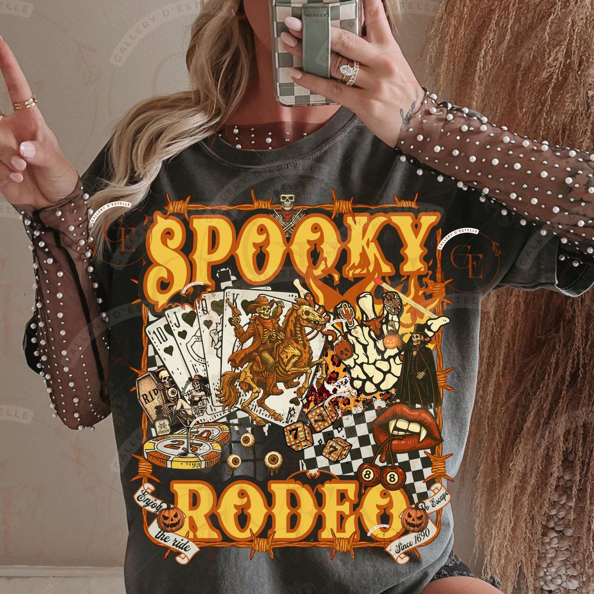 Person wearing a 'Spooky Rodeo' themed t-shirt with Halloween graphics.