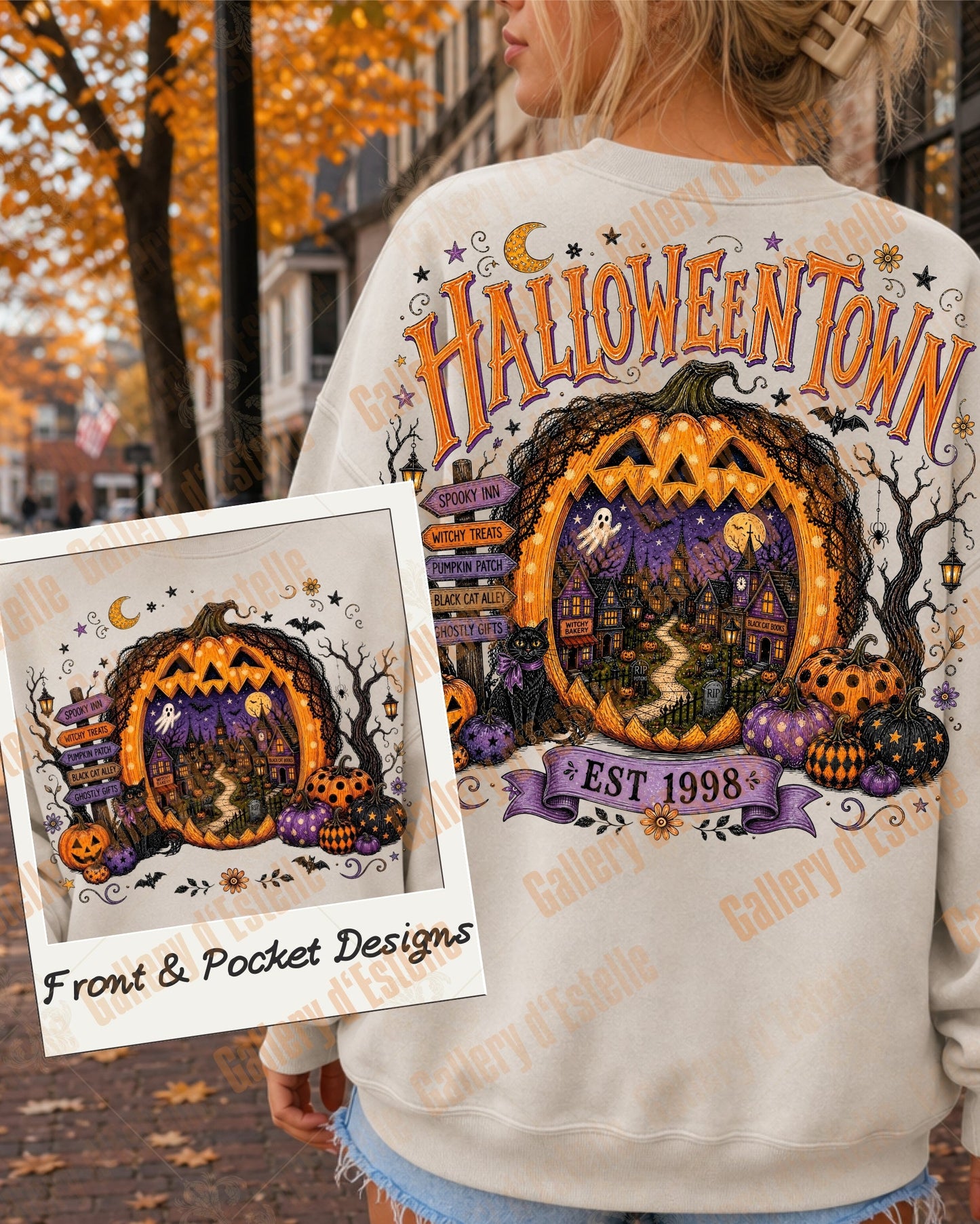A woman outdoors wearing a white sweatshirt with a large Halloween-themed graphic on the back reading 'HALLOWEENTOWN' and showing a jack-o'-lantern porch scene. A smaller inset shows the matching pocket design.