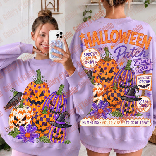 A woman modeling a lavender-purple sweatshirt with a large Halloween graphic print featuring jack-o'-lanterns, pumpkins, flowers, a bird, and decorative text. The image shows both the front and back views of the sweatshirt, with the model taking a mirror selfie on the left and wearing the back design on the right.