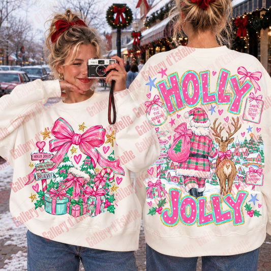 Two women modeling a cream-colored Christmas sweatshirt, showing both the front and back designs. The front features a pink gift bow and presents, while the back features 'HOLLY JOLLY' text, Santa, a reindeer, and a plaid pattern.
