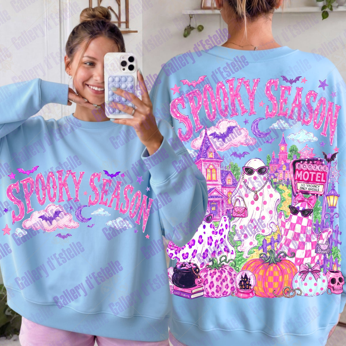 A light blue crewneck sweatshirt shown from both front and back on a model. The front features pink 'SPOOKY SEASON' text with glam ghosts and pumpkin graphics.