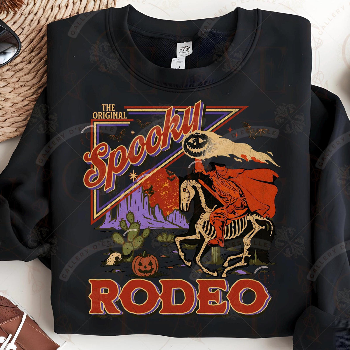 Black sweatshirt with 'The Original Spooky Rodeo' graphic design featuring a skeleton on a horse.
