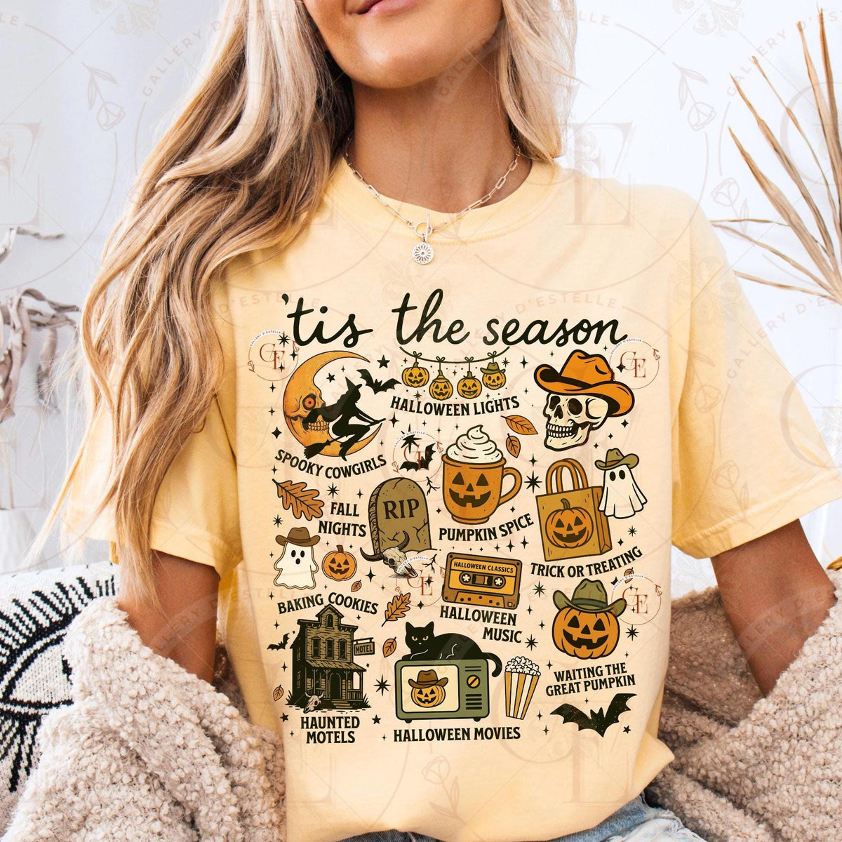 Person wearing a yellow t-shirt with Halloween-themed graphics and text.