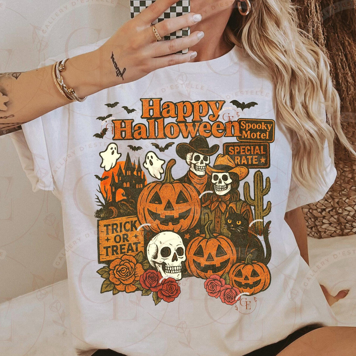 Person wearing a white t-shirt with Halloween-themed graphics and text.