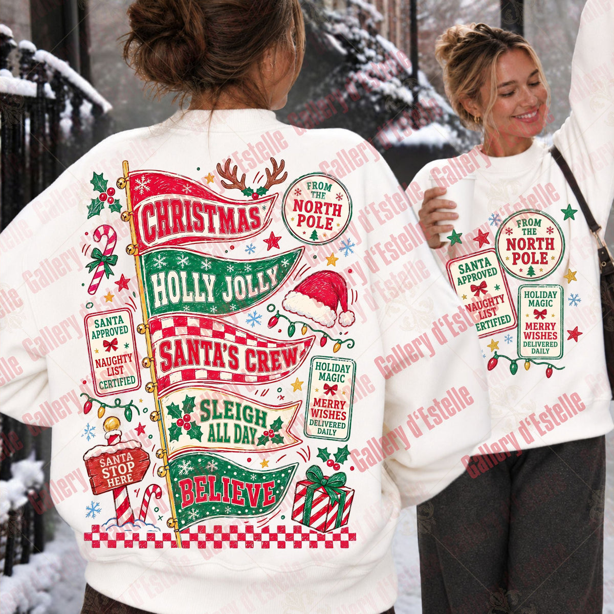 Two women outdoors in a snowy setting wearing matching white Christmas sweatshirts. The back view shows a large festive graphic with red, green, and gold holiday text and illustrations, while the front view shows a smaller matching front print.