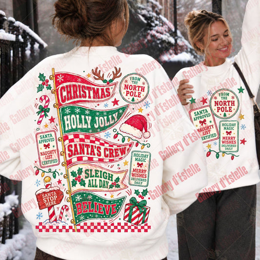 Two women outdoors in a snowy setting wearing matching white Christmas sweatshirts. The back view shows a large festive graphic with red, green, and gold holiday text and illustrations, while the front view shows a smaller matching front print.
