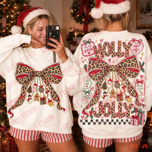 A woman takes a mirror selfie showing the front and back of a white Christmas sweater. The sweater features a large leopard-print bow with red and pink accents, 'HOLLY JOLLY' text, and festive details.