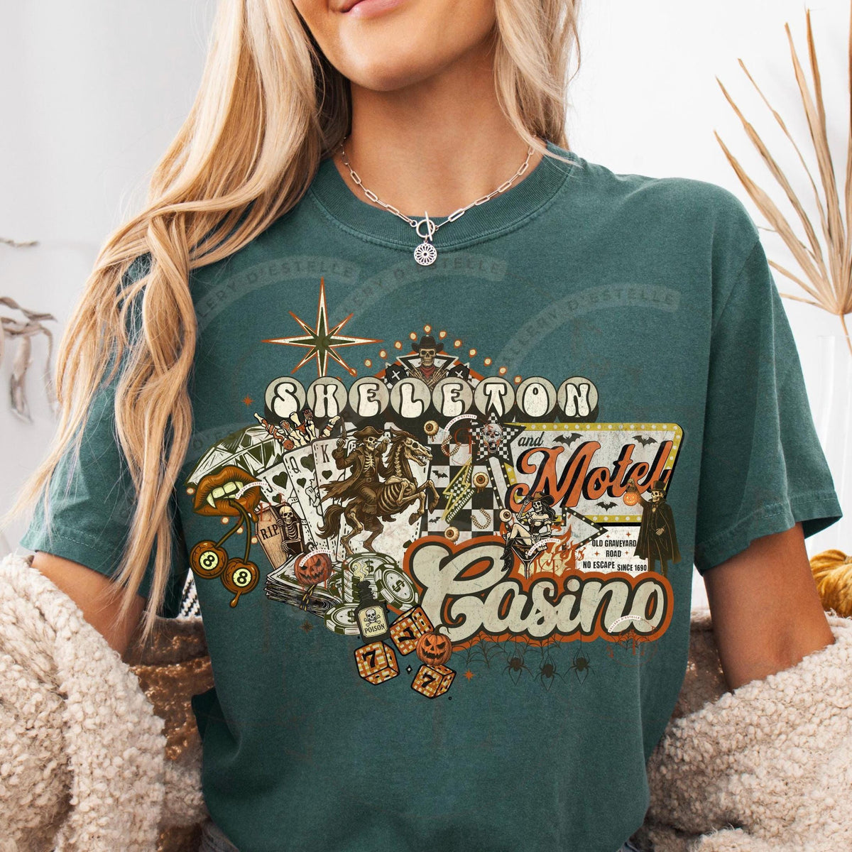 Person wearing a green t-shirt with a 'Skeleton Motel Casino' graphic design.