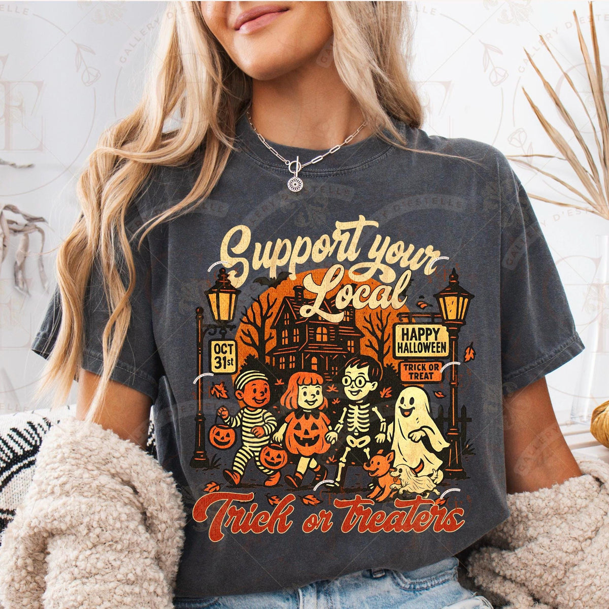 Person wearing a Halloween-themed t-shirt with graphics and text.