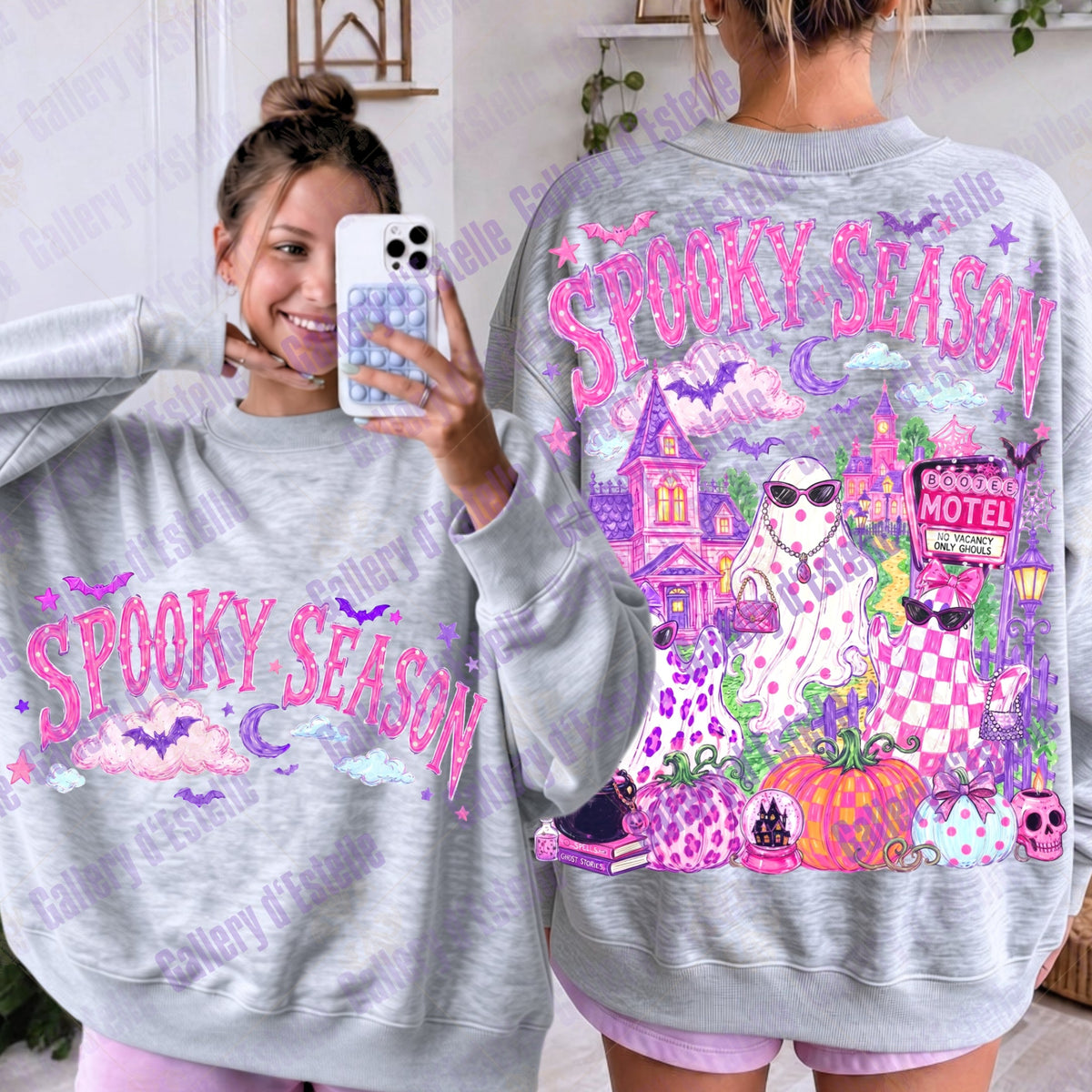 A light gray heather crewneck sweatshirt with a vibrant pink and purple 'Spooky Season' graphic, shown from both front and back on a model. The back features a detailed illustration of three coquete ghosts, a haunted house, a motel sign, pumpkins, and bats.
