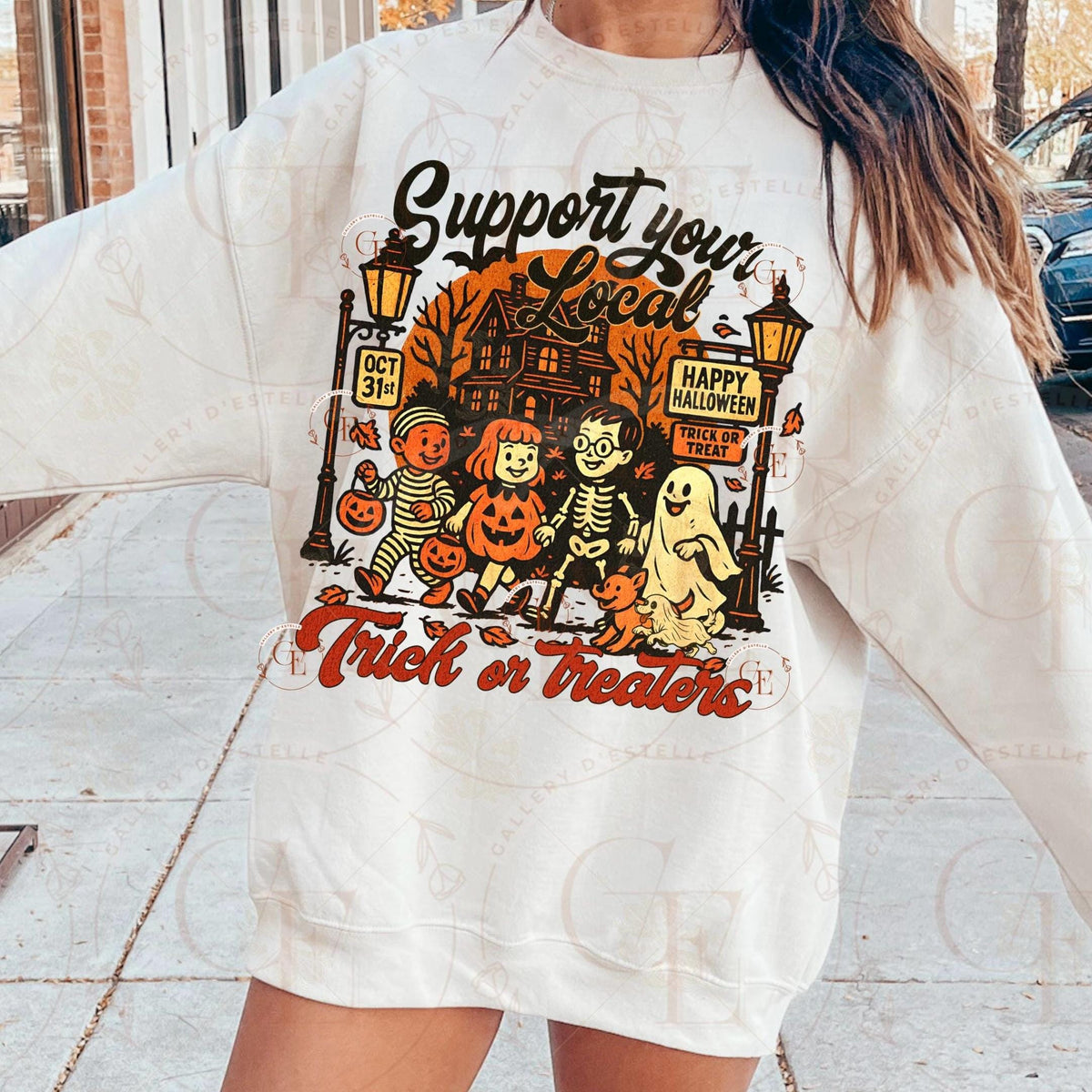 Person wearing a white sweatshirt with Halloween-themed graphic and text.