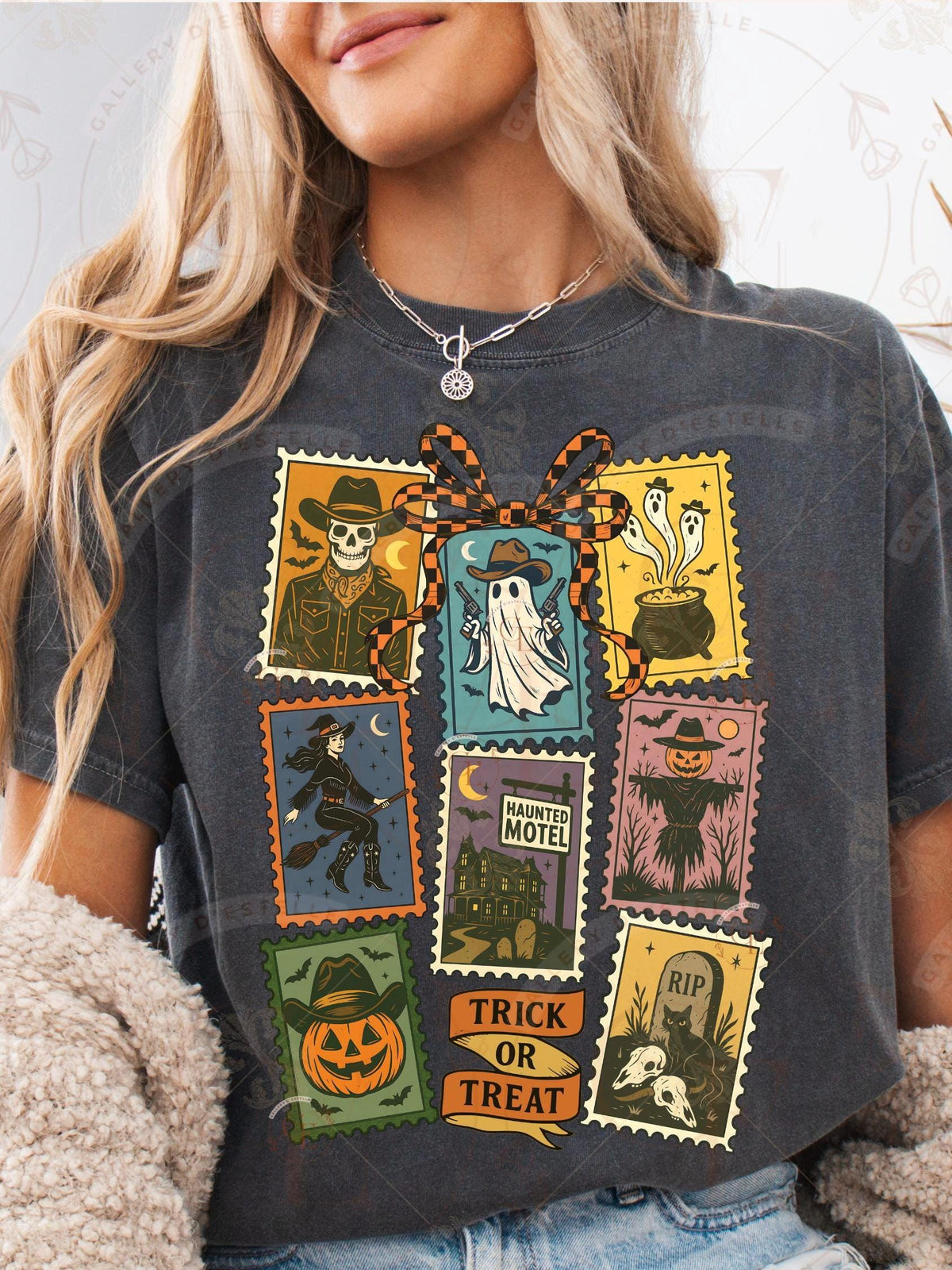 Person wearing a dark gray t-shirt with Halloween-themed graphic designs.