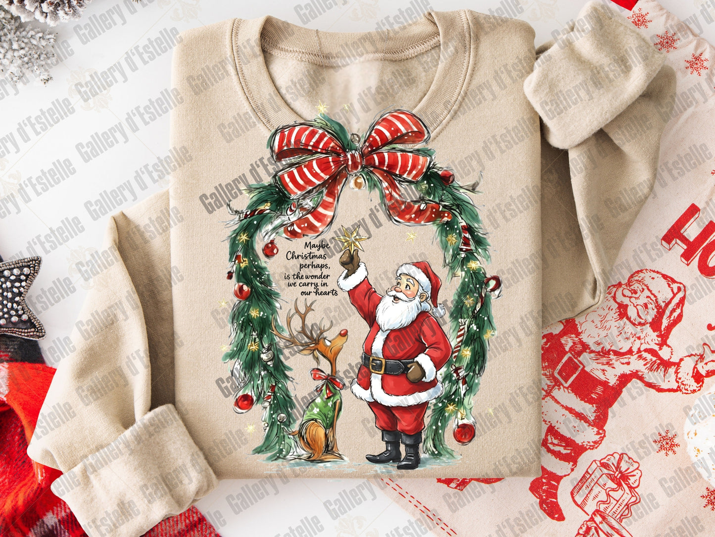 Beige sweatshirt with Christmas design featuring Santa Claus, reindeer, and wreath on a white background.