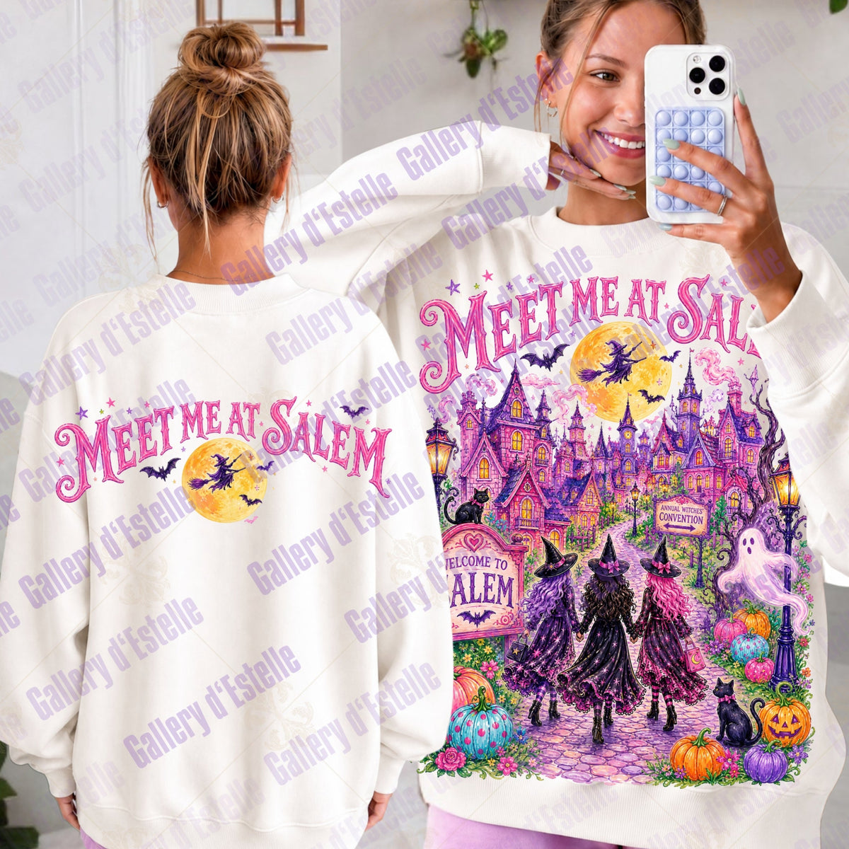 A woman modeling a white long-sleeve sweatshirt with a colorful Halloween-themed graphic that reads 'MEET ME AT SALEM.' The image shows both the front and back views of the sweatshirt, with the front featuring a pink & purple haunted castle, witches, pumpkins, ghosts, and a full moon, and the back showing a smaller matching graphic.