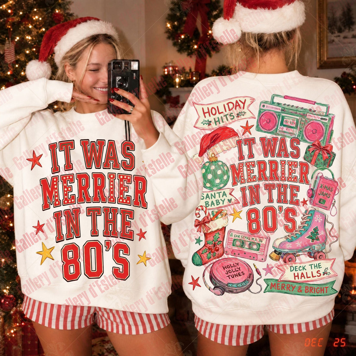 Two women wearing matching Christmas-themed sweatshirts, shown from the front and back in a holiday decorated room. The white crewneck sweatshirts feature red and green retro graphics with text reading 'IT WAS MERRIER IN THE 80'S' and festive illustrations like boomboxes, stockings, and a Santa hat.