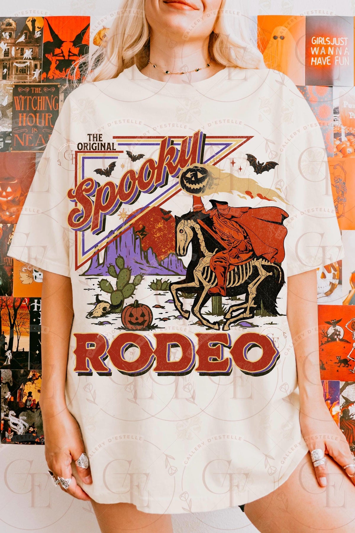 Person wearing a 'Spookill Rodeo' themed t-shirt with Halloween graphics in front of a Halloween-themed background.