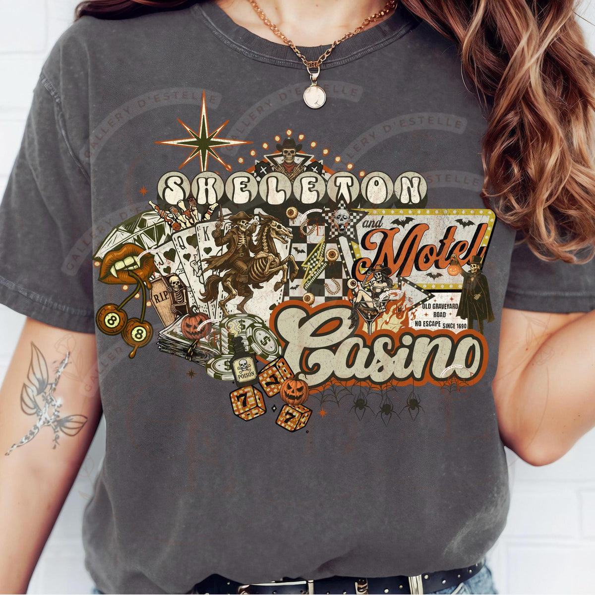 Person wearing a t-shirt with a 'Skeleton and Motel Casino' graphic design.