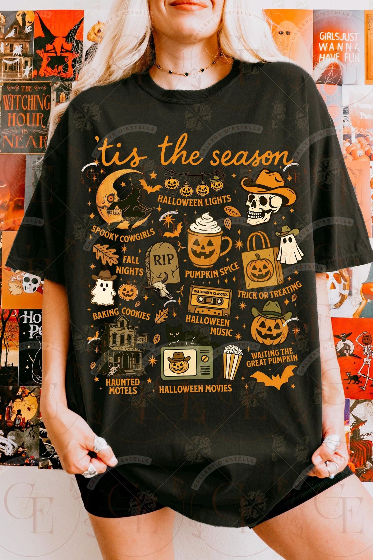 Person wearing a black t-shirt with Halloween-themed graphics and text.