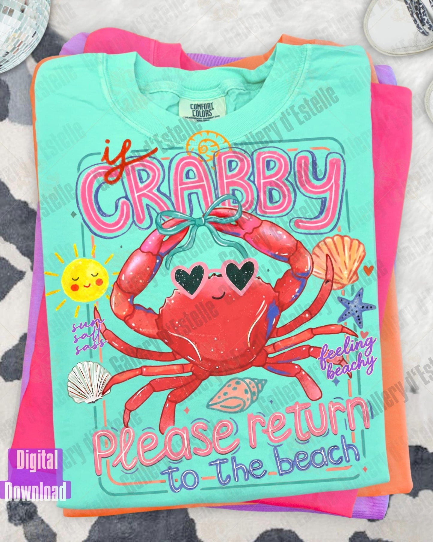 Colorful t-shirt with a crab design and text on a textured surface