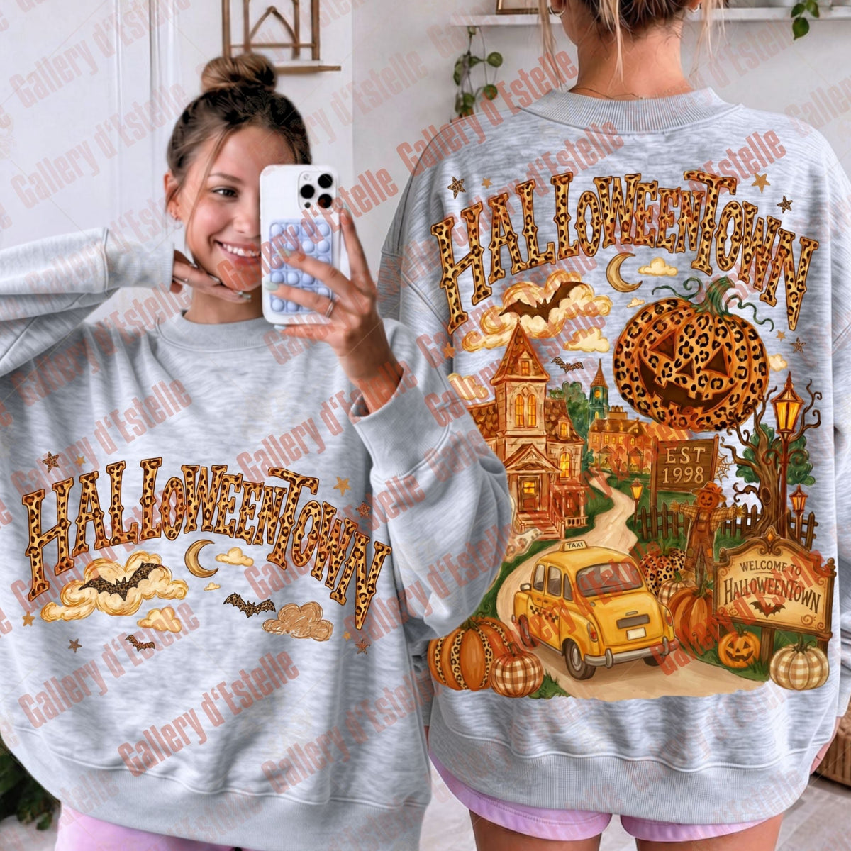A light gray crewneck sweatshirt shown from both front and back on a model. The front features a 'Halloween Town' graphic with a haunted house, moon, and bats.