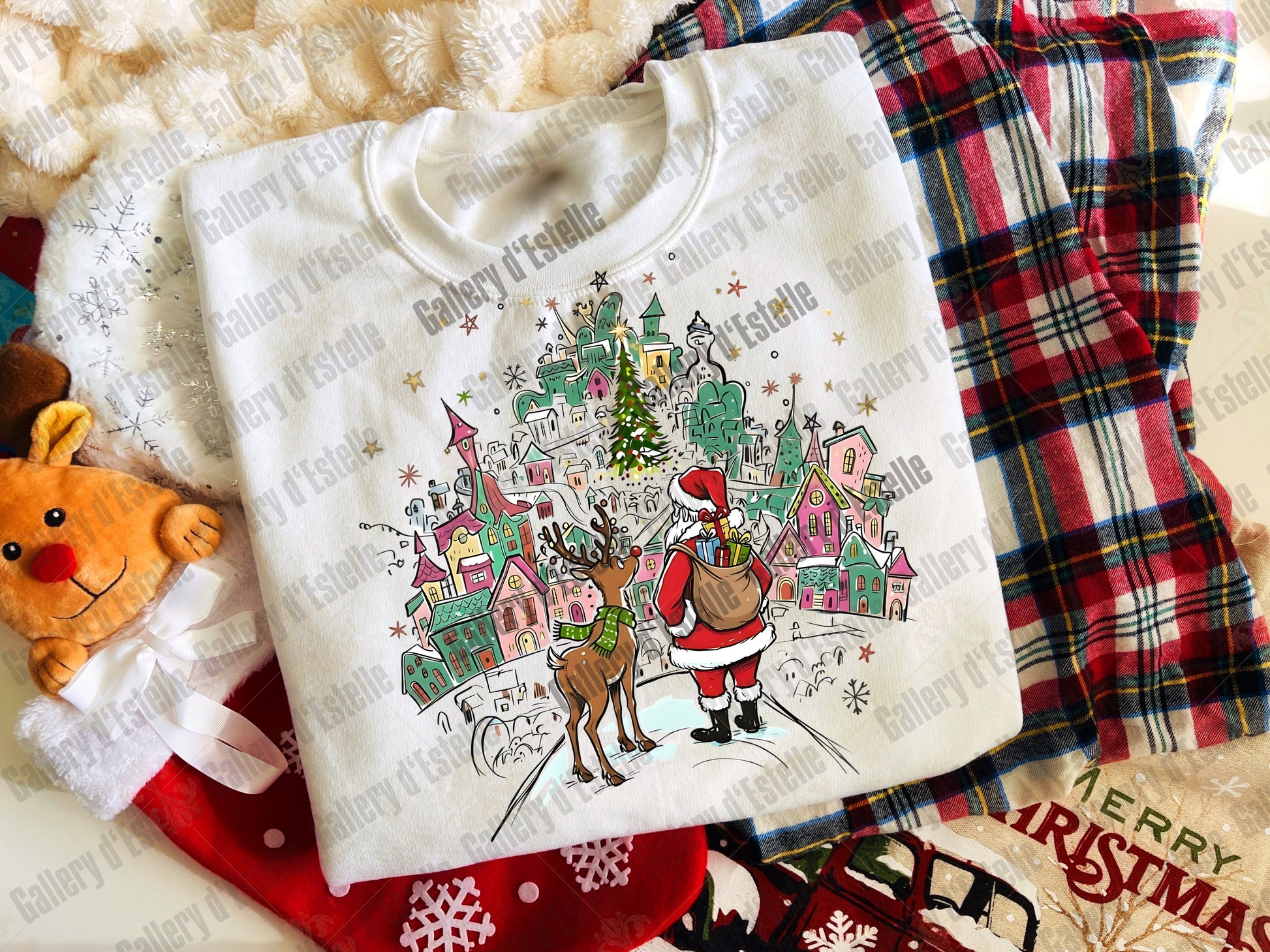 White sweatshirt with Christmas design featuring Santa and reindeer on a plaid fabric background.