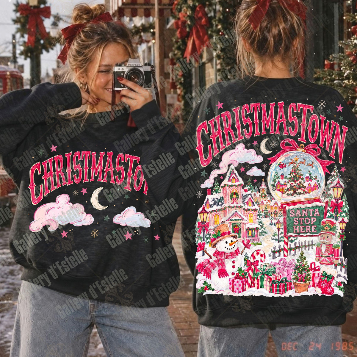 Two models wearing black Christmas-themed sweatshirts, one showing the front with 'CHRISTMASTOWN' and clouds, and the other showing the back with a detailed Santa village scene and 'CHRISTMASTOWN' text, set against a holiday storefront background.