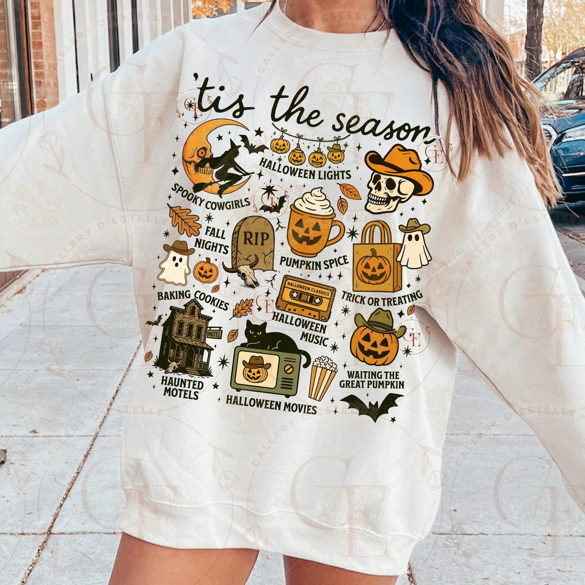 White t-shirt with Halloween-themed graphics worn by a person outdoors.