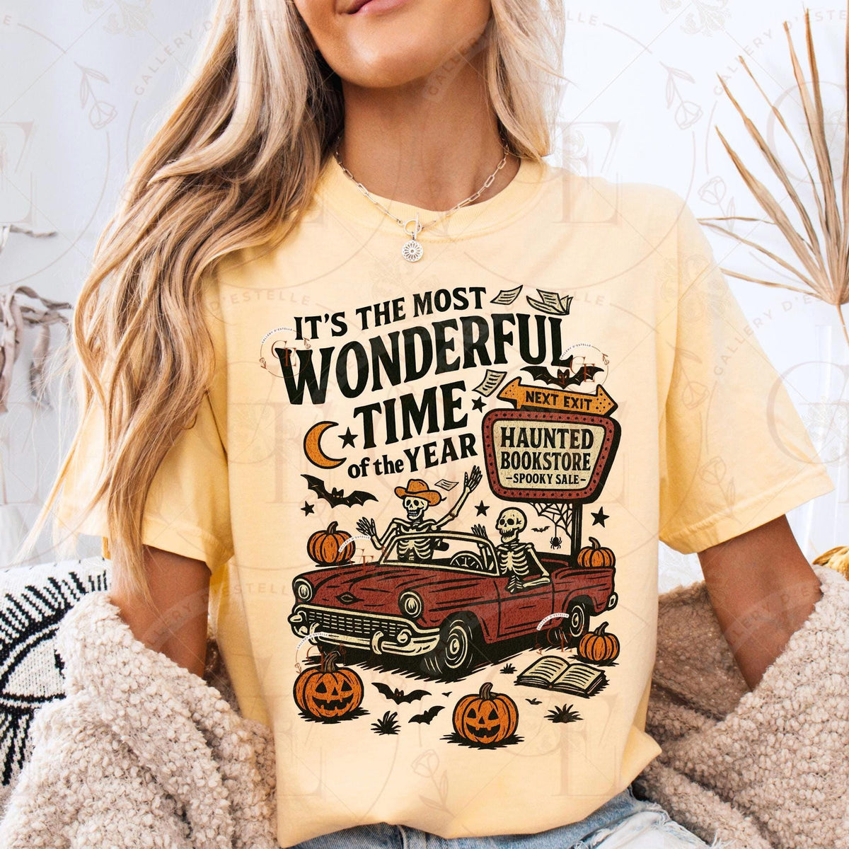 Person wearing a yellow t-shirt with Halloween-themed graphic and text.