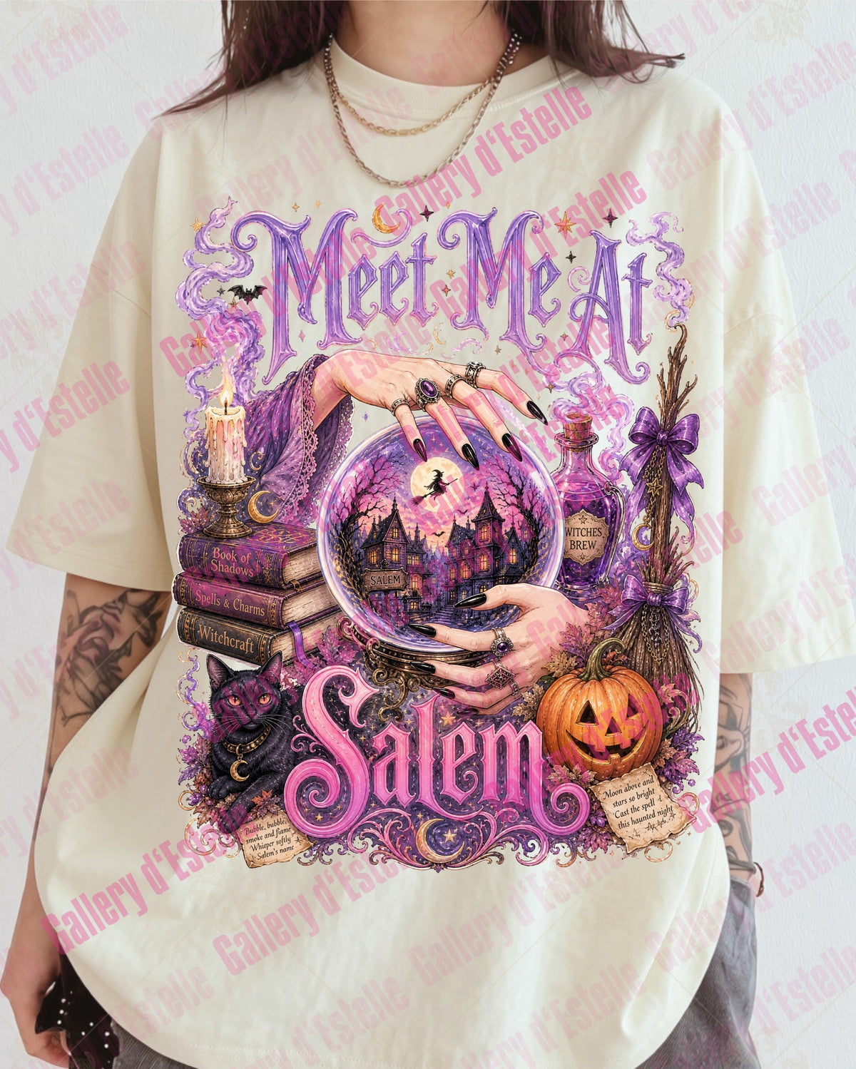 A person wearing an oversized cream-colored graphic T-shirt with a purple and pink Halloween-themed design featuring the words 'Meet Me At Salem' and a crystal ball illustration.
