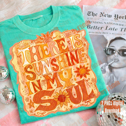 Turquoise t-shirt with decorative text and graphics on a surface with a magazine and disco balls.