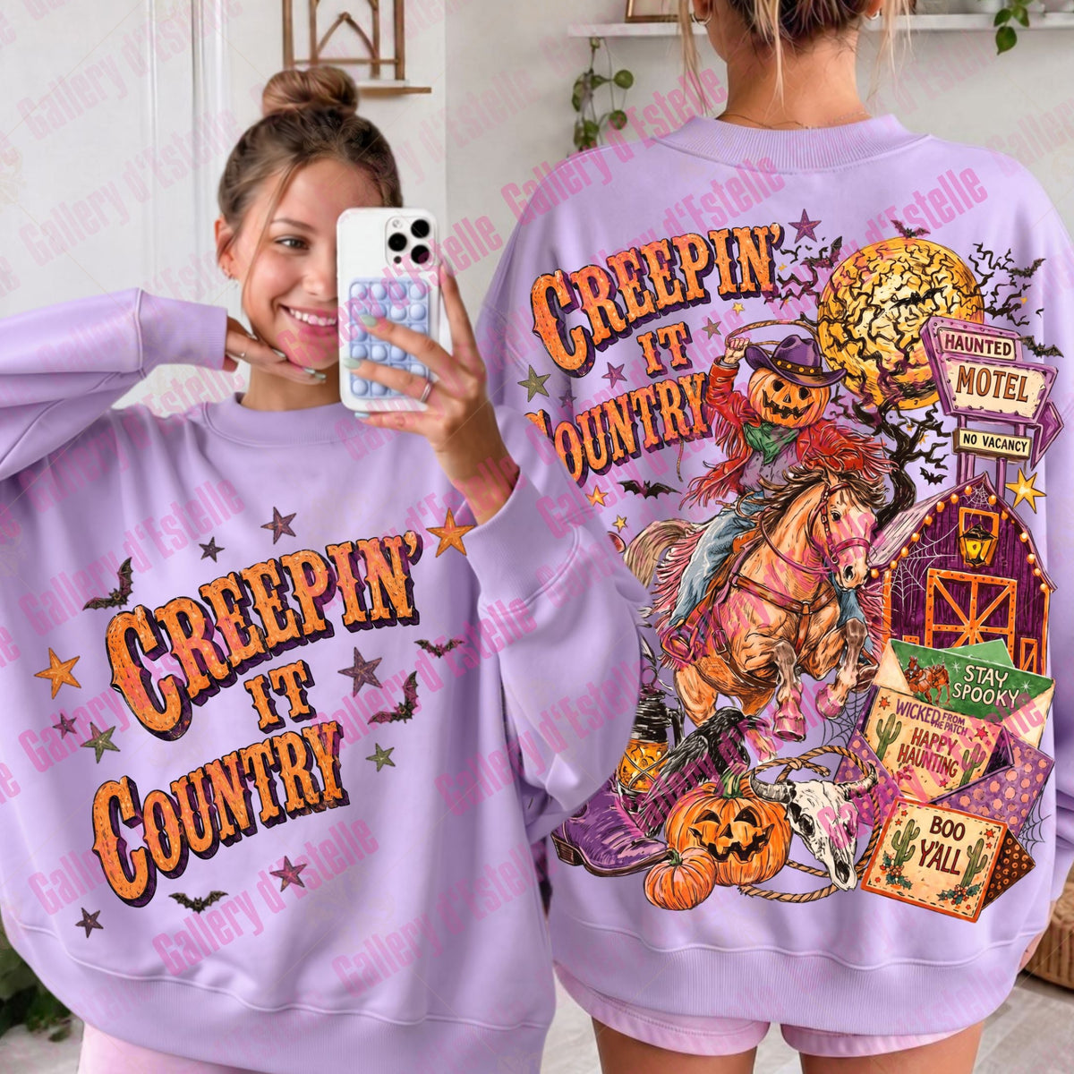 A woman modeling a lavender purple graphic sweatshirt, showing both the front and back designs. The front features the text 'CREEPIN' IT COUNTRY' in orange and yellow.