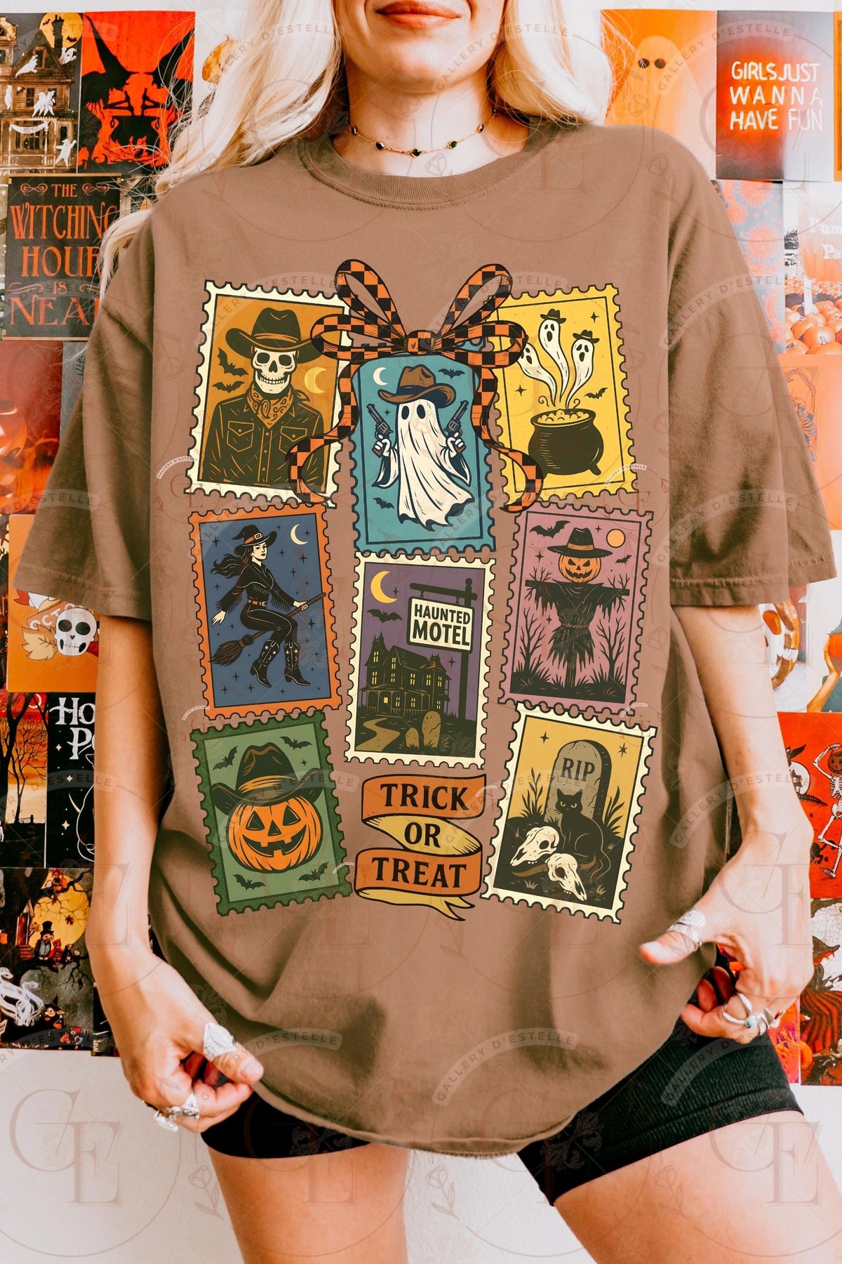 Person wearing a brown t-shirt with Halloween-themed graphic design.