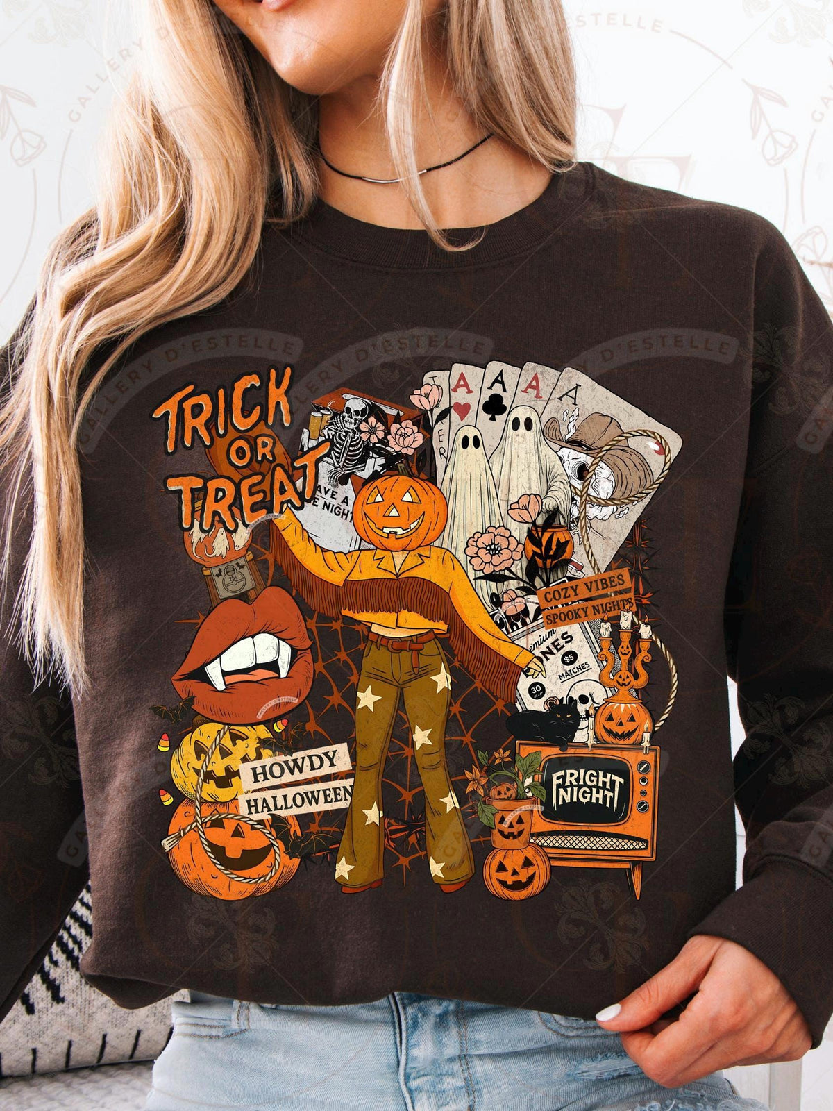 Person wearing a brown sweatshirt with Halloween-themed graphics