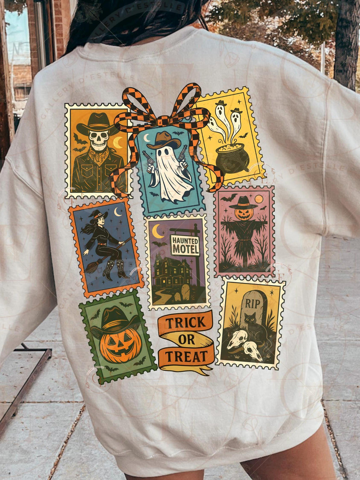 Person wearing a white sweatshirt with Halloween-themed stamps and 'Trick or Treat' text on the back.