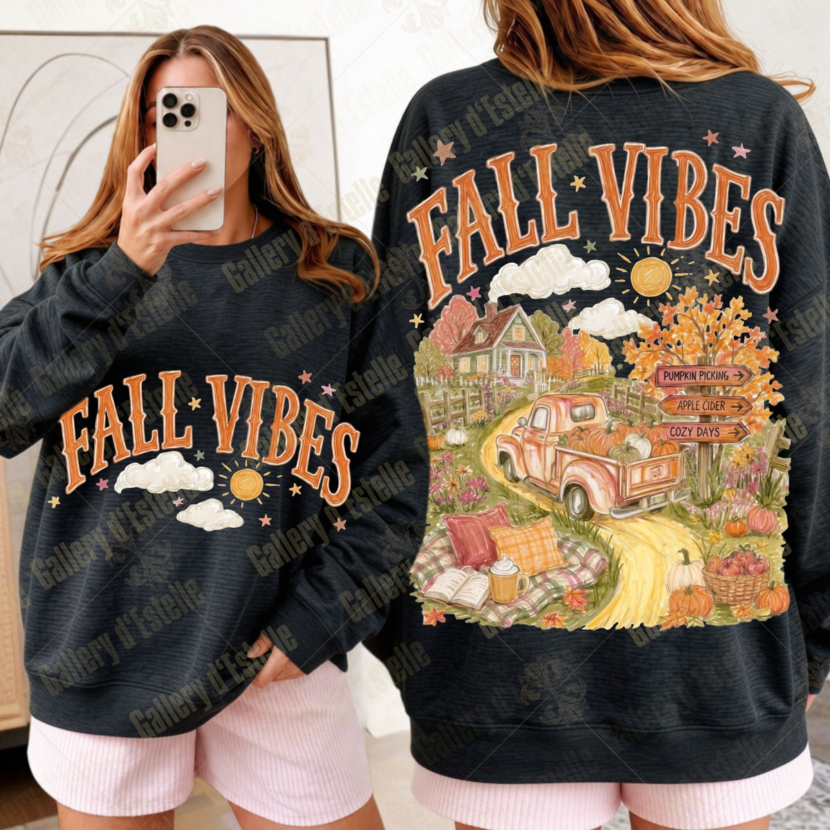 A black crewneck sweatshirt with 'FALL VIBES' text, shown in a mirror selfie and back view. The back features a large autumn-themed illustration of a pickup truck, house, and fall foliage.
