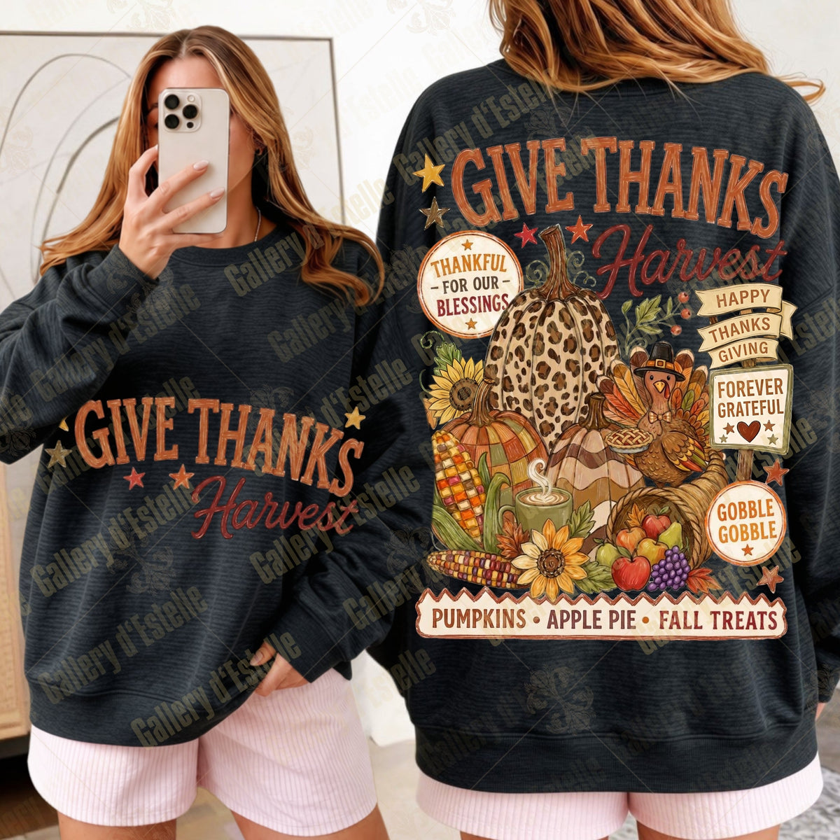 A woman modeling a black long-sleeve sweatshirt with a large autumn harvest graphic on the back and 'GIVE THANKS Harvest' text on the front, shown in a mirror-selfie style alongside a clearer back view of the garment.