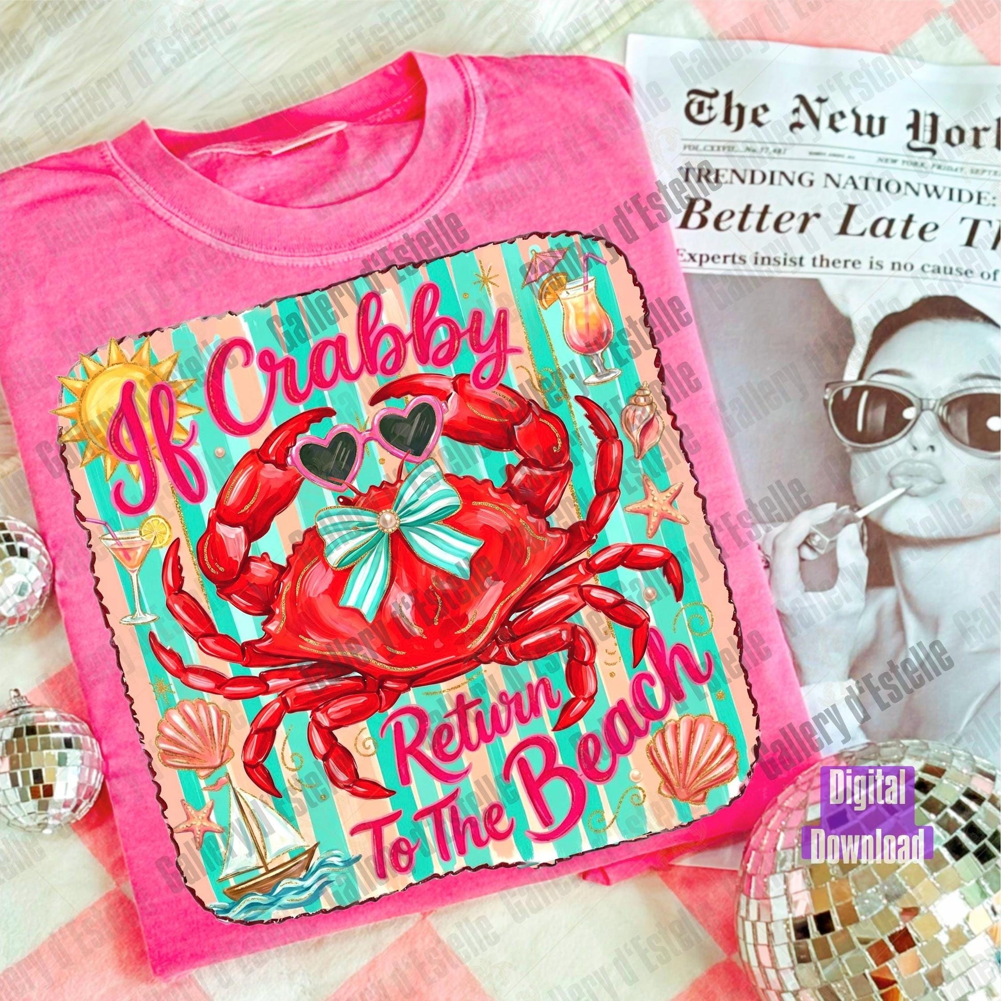 Pink t-shirt with a colorful crab design and text, placed on a surface with a newspaper underneath.