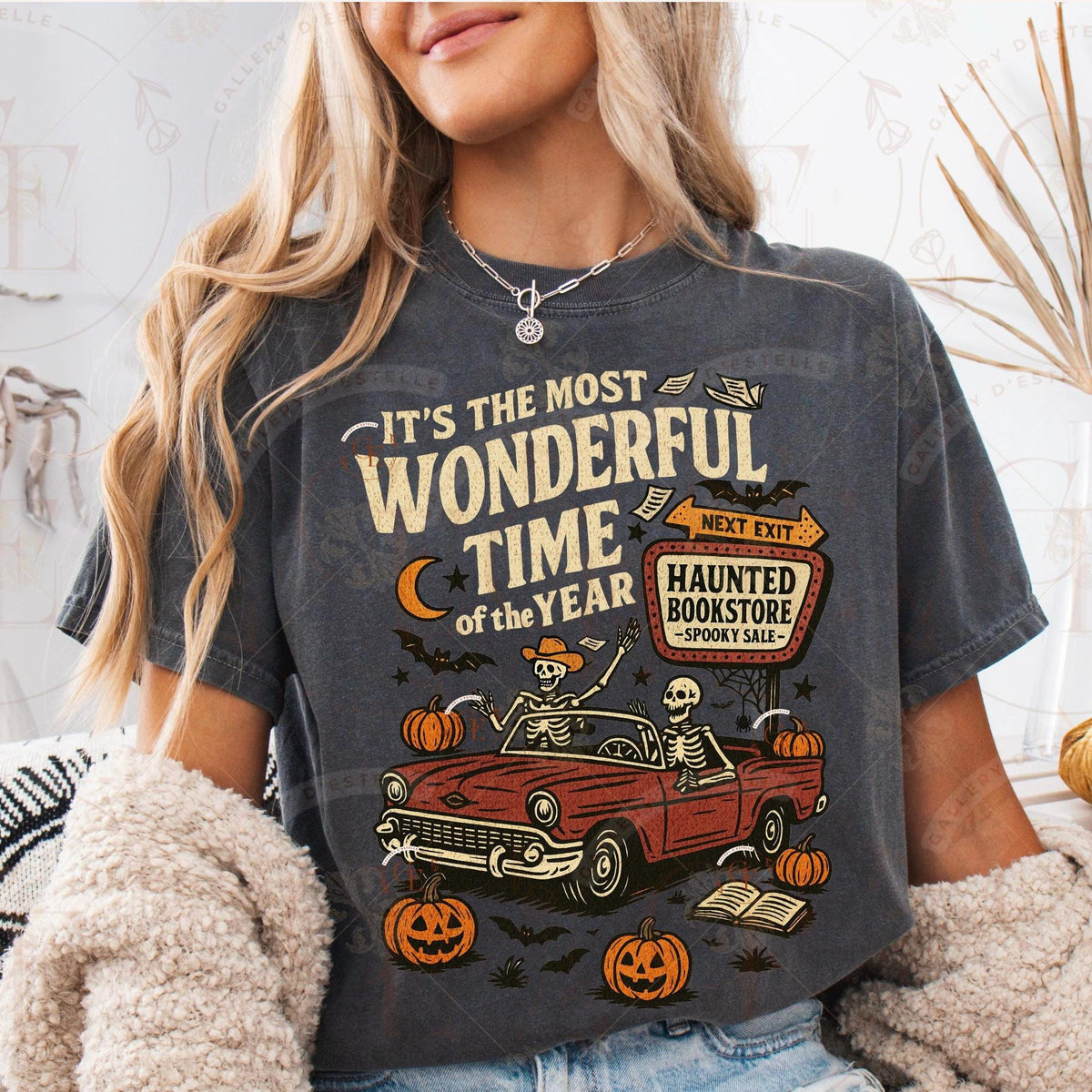 Person wearing a Halloween-themed t-shirt with a graphic of a red car, pumpkins, and text.