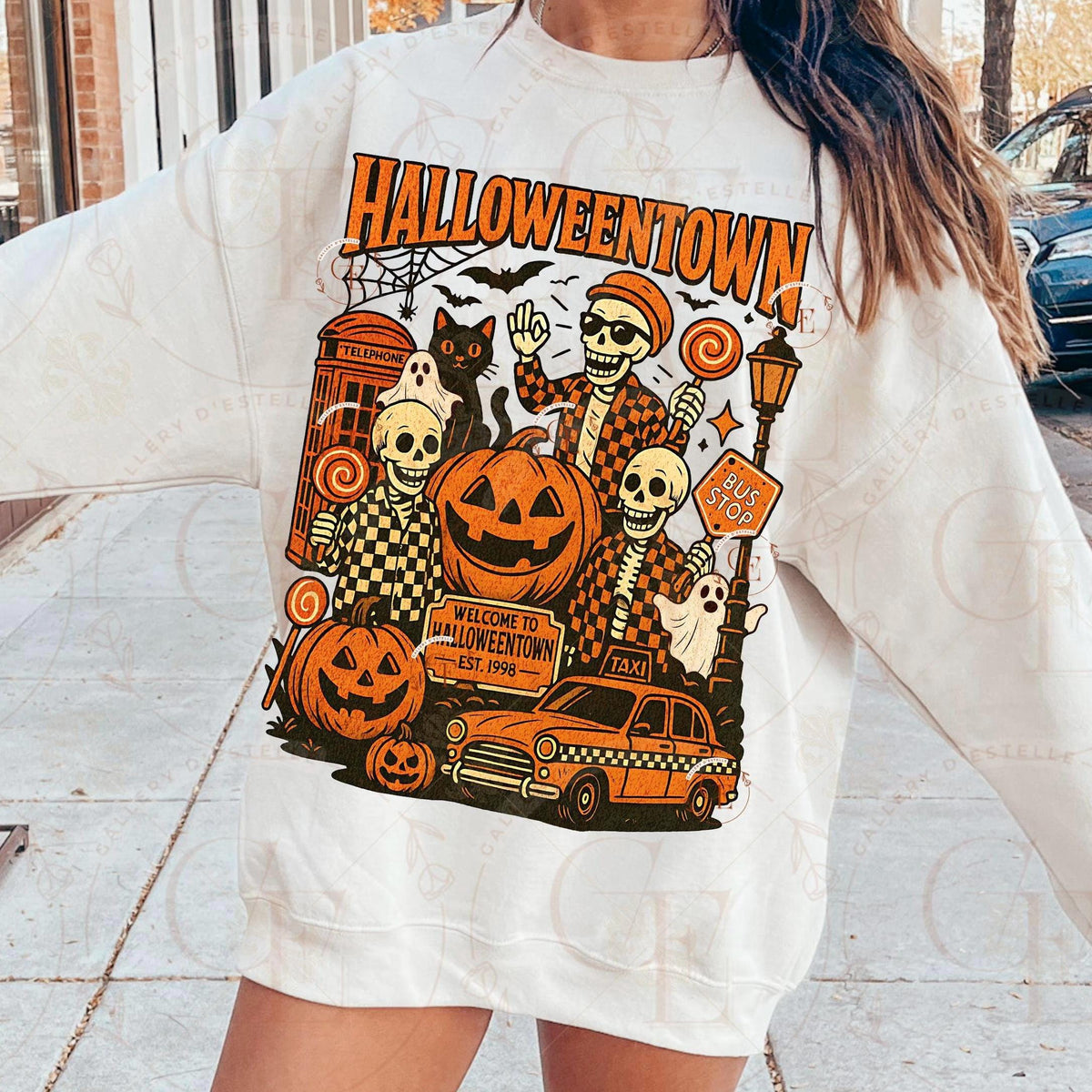 Person wearing a white sweatshirt with a 'Halloweentown' graphic design.