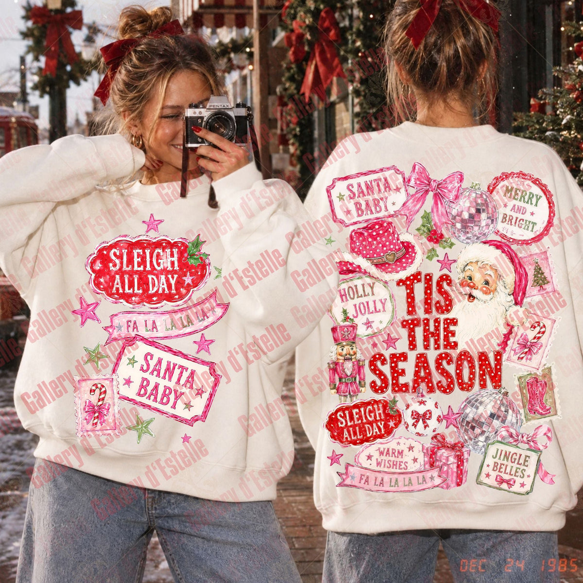 Two women shown from the back wearing matching cream-colored Christmas sweatshirts with large red and pink holiday graphics and text such as 'Sleigh All Day,' 'Santa Baby,' and 'Tis the Season.'.