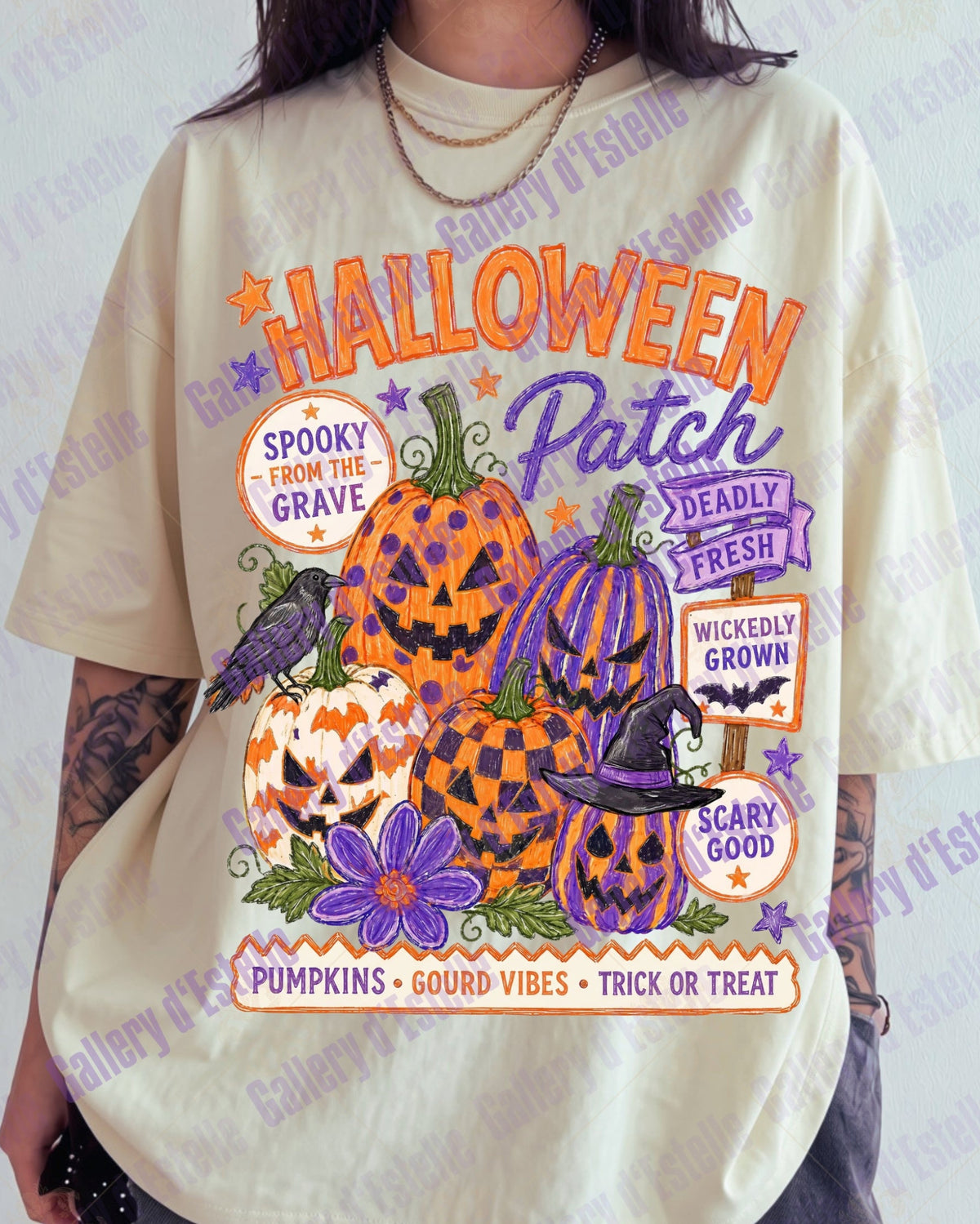 A person wearing an oversized cream-colored graphic t-shirt with a colorful Halloween-themed print featuring pumpkins, a witch hat, a purple bird, and text like 'Halloween Patch' and 'Spooky from the Grave'.