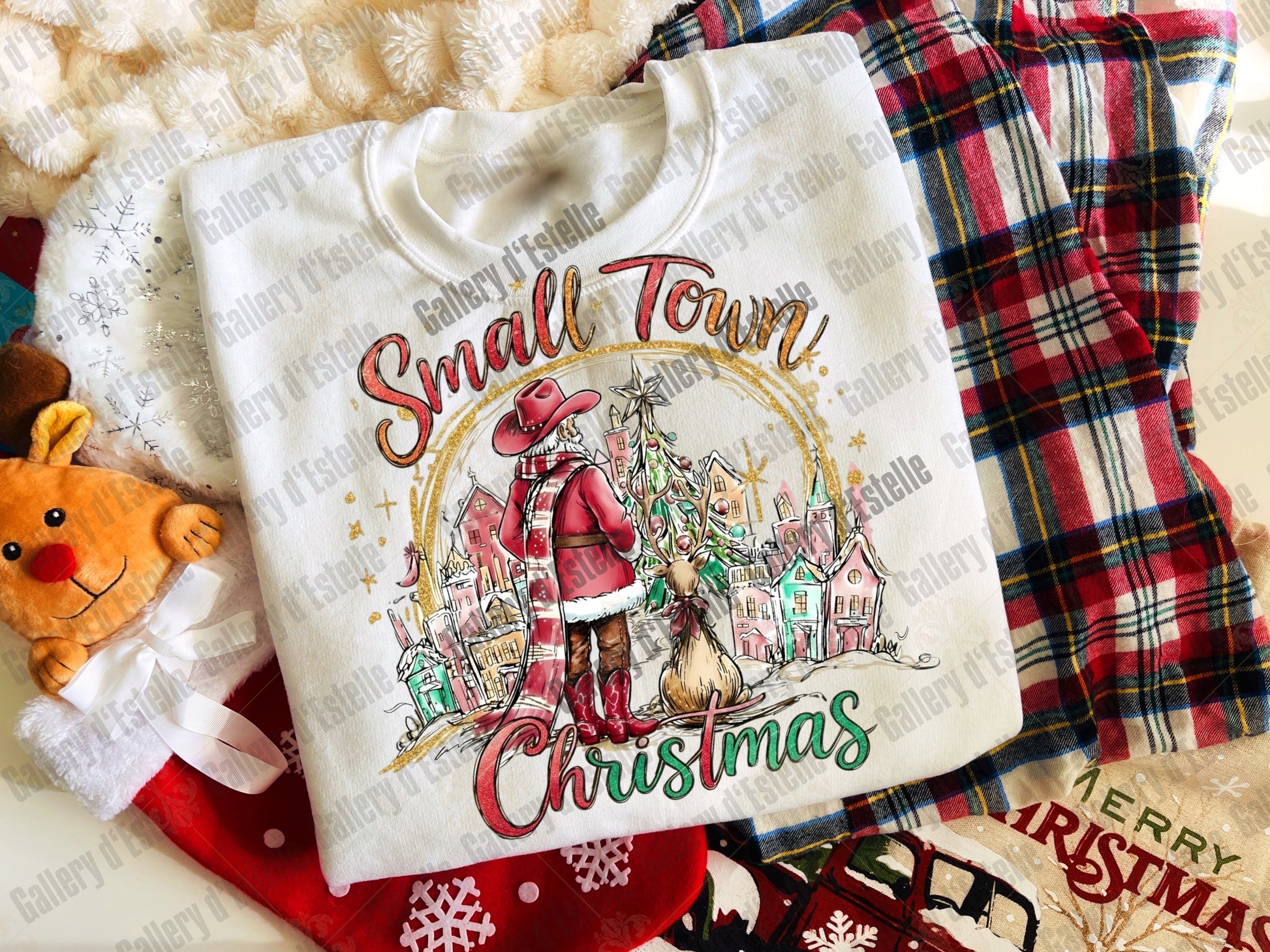 White sweatshirt with 'Small Town Christmas' design on a plaid fabric background