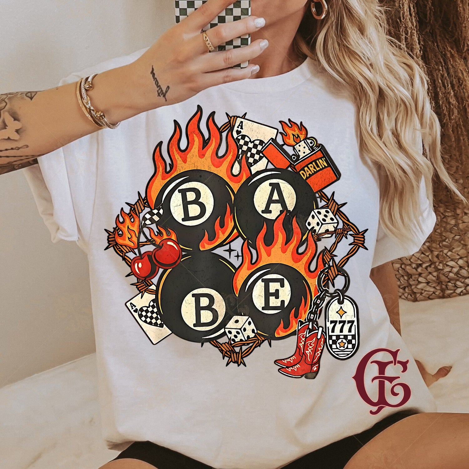 Person wearing a white t-shirt with a colorful graphic design featuring flames and text.