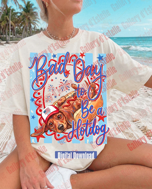 Person wearing a 4th of July t-shirt with a Dachshund dog graphic and 'Bad Day to be a Hotdog' text at the beach.