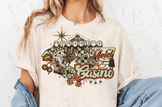 Person wearing a white t-shirt with 'Skeleton and Motel Casino' graphic design.
