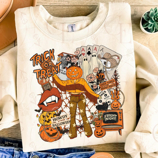 White sweatshirt with Halloween-themed graphics on a wooden surface